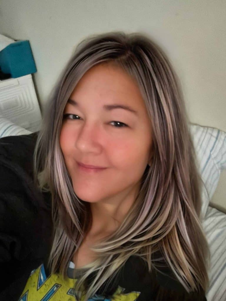 Lyn, a chronic illness blogger living with dysautonomia, small fiber neuropathy, and gastroparesis, smiling at the camera.